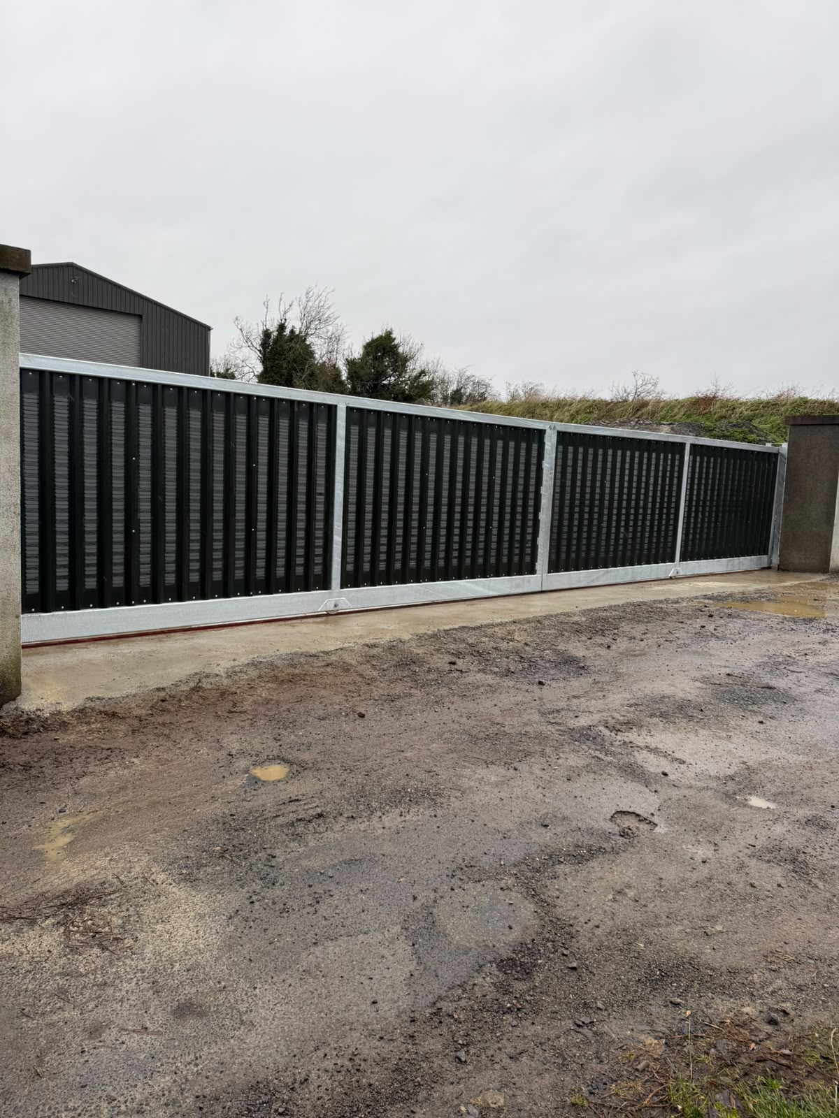 Black made to measure steel entrance gates and matching railings on the driveway of an Irish country house